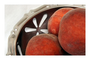 stainless steel bowl close up of edges with peaches